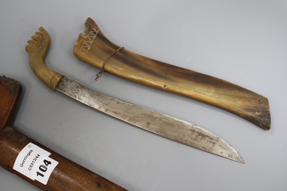 A Kris with hardwood handle and scabbard and another similar with horn scabbard